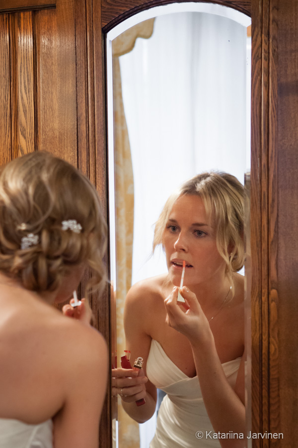 bride putting on lipstick
